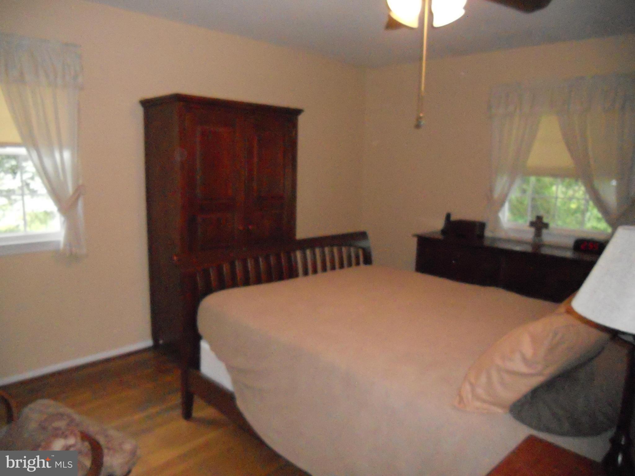 19129 Willow Grove Road Olney, MD 20832 - Photo 7 of 18 a bedroom with a bed and a potted plant