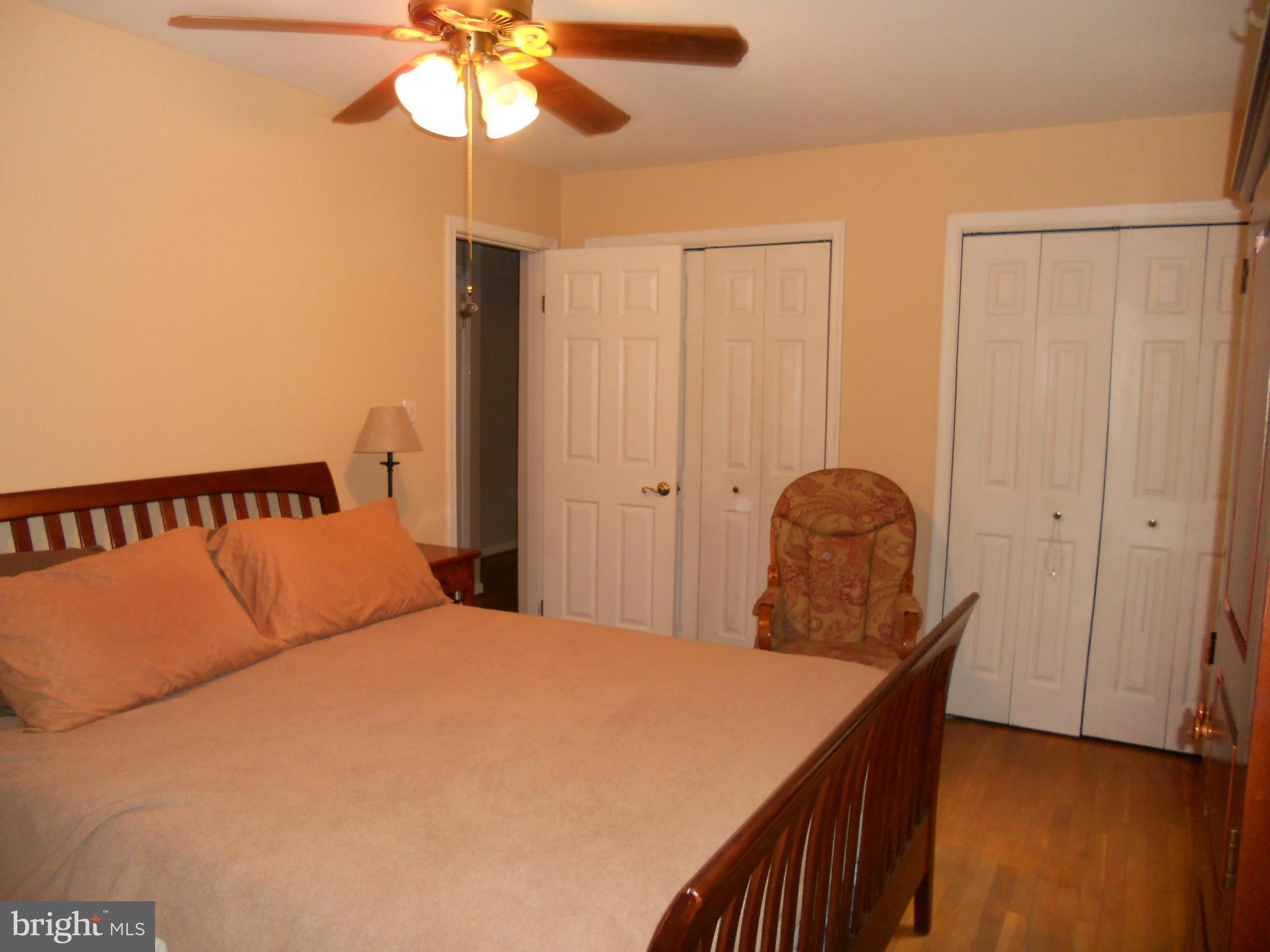 19129 Willow Grove Road Olney, MD 20832 - Photo 9 of 18 a bedroom with a bed and a chandelier
