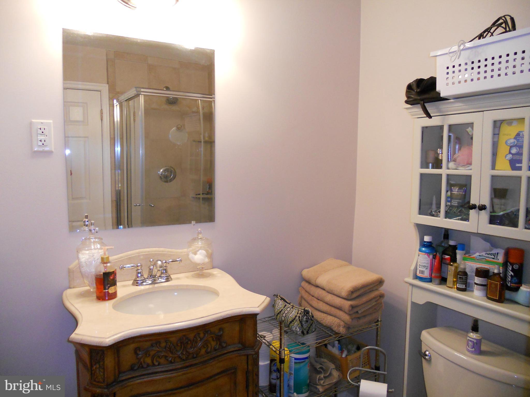 19129 Willow Grove Road Olney, MD 20832 - Photo 10 of 18 a bathroom with a sink toilet and shower