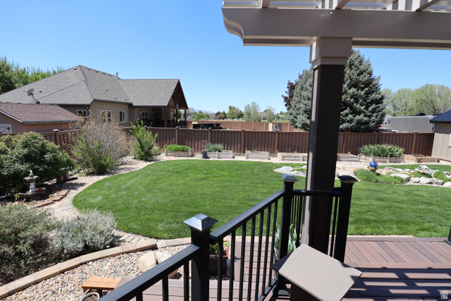 1055 North 1000 East Mapleton, UT 84664 - Photo 77 of 112 Expansive backyard featuring a manicured lawn, established landscaping, and a privacy fence