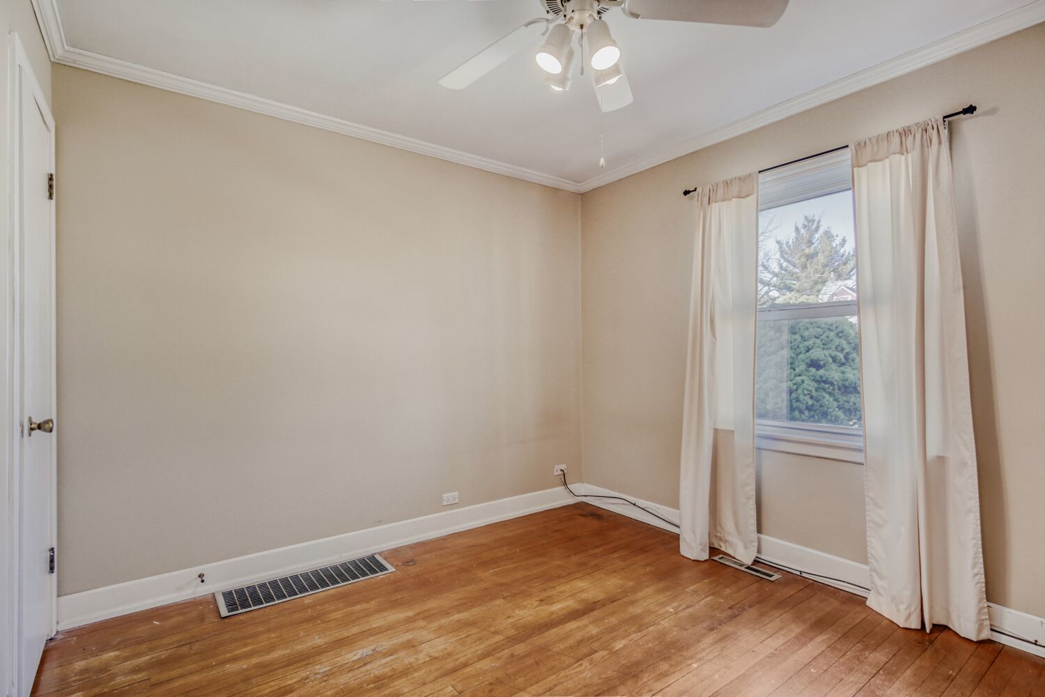 3659 Madison Street Lansing, IL 60438 - Photo 14 of 28 an empty room with wooden floor fan and windows