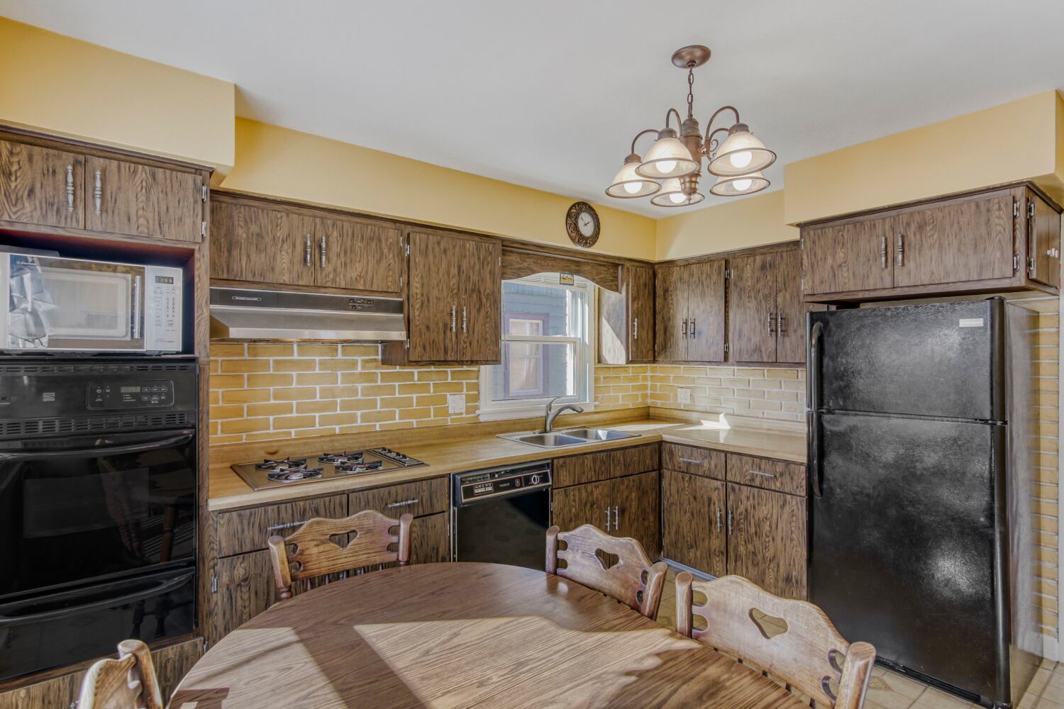 3659 Madison Street Lansing, IL 60438 - Photo 8 of 28 a kitchen with stainless steel appliances granite countertop a sink stove and refrigerator