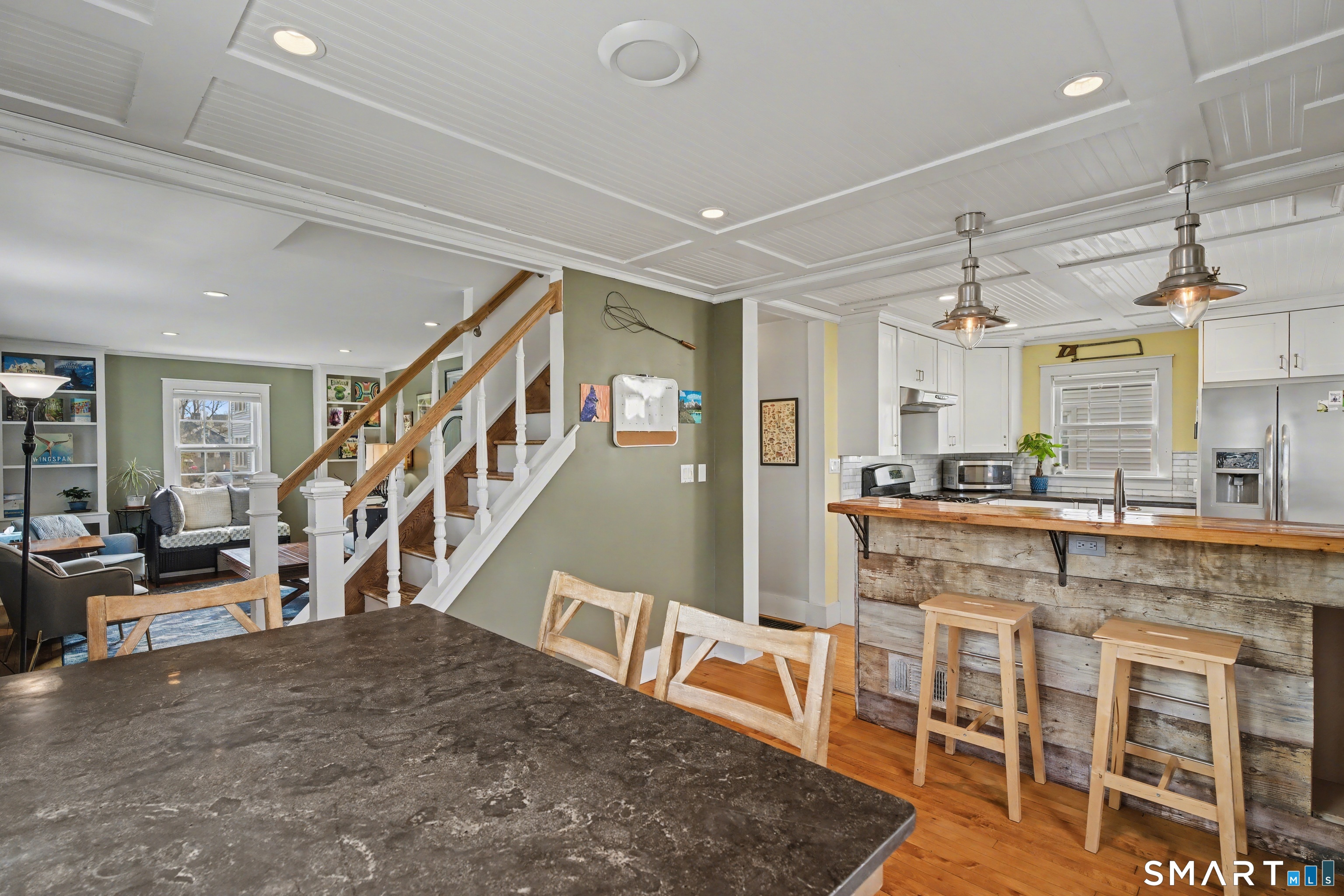 4 Dallas Street Hamden, CT 06514 - Photo 6 of 36 a dining hall with stainless steel appliances granite countertop a living room and couches with the kitchen view