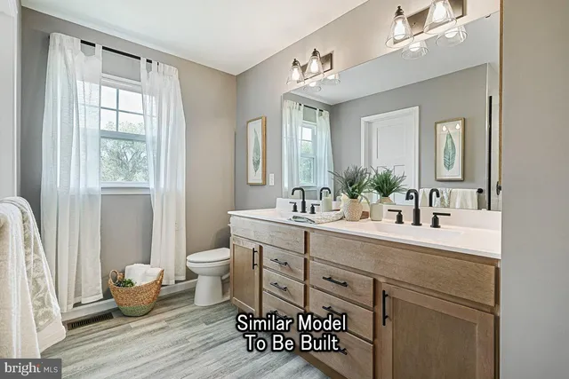 a spacious bathroom with a double vanity sink a mirror and a shower