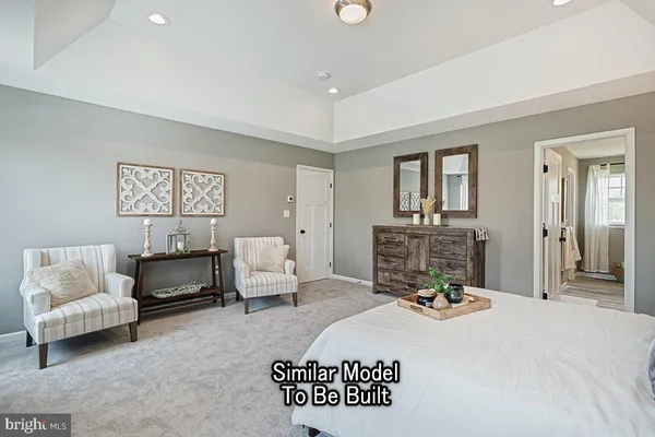 a bedroom with a bed a couch and dresser