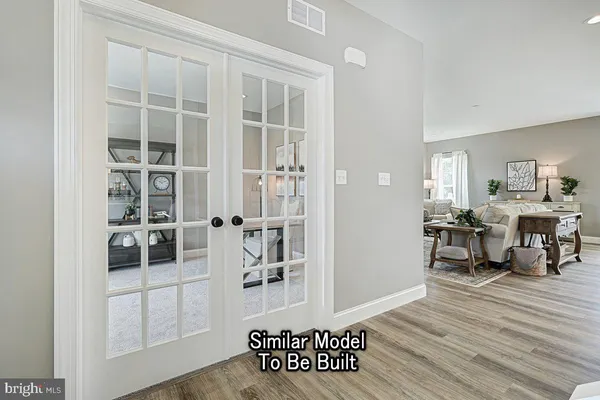 a view of a livingroom with furniture and hardwood floor