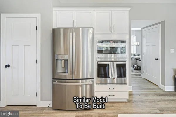 a view of kitchen with stainless steel appliances granite countertop a refrigerator and a stove top oven