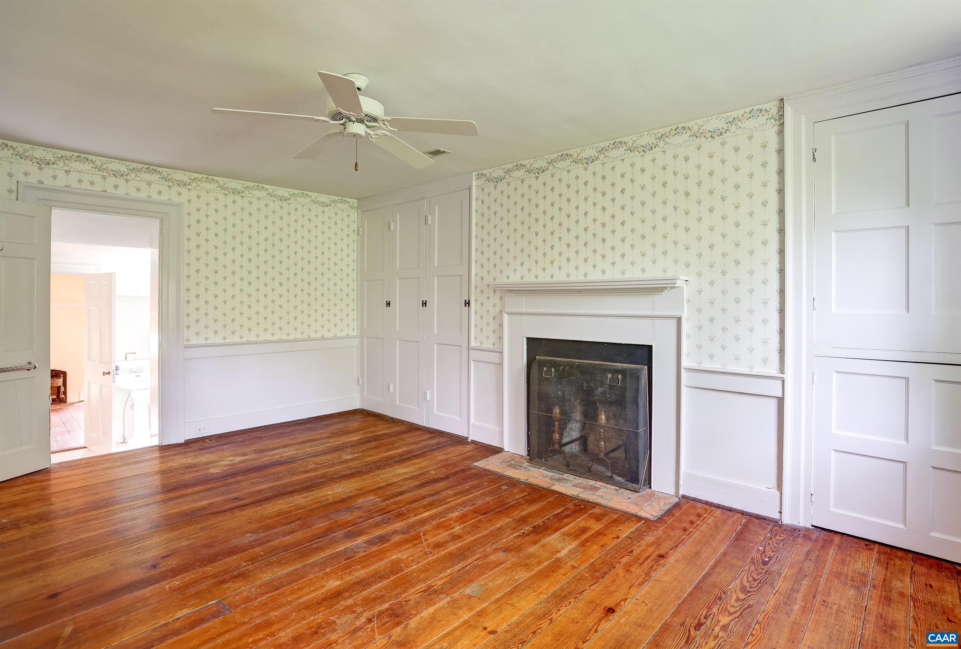 2051 Polo Grounds Road Charlottesville, VA 22911 - Photo 24 of 74 a view of an empty room with wooden floor and a fireplace