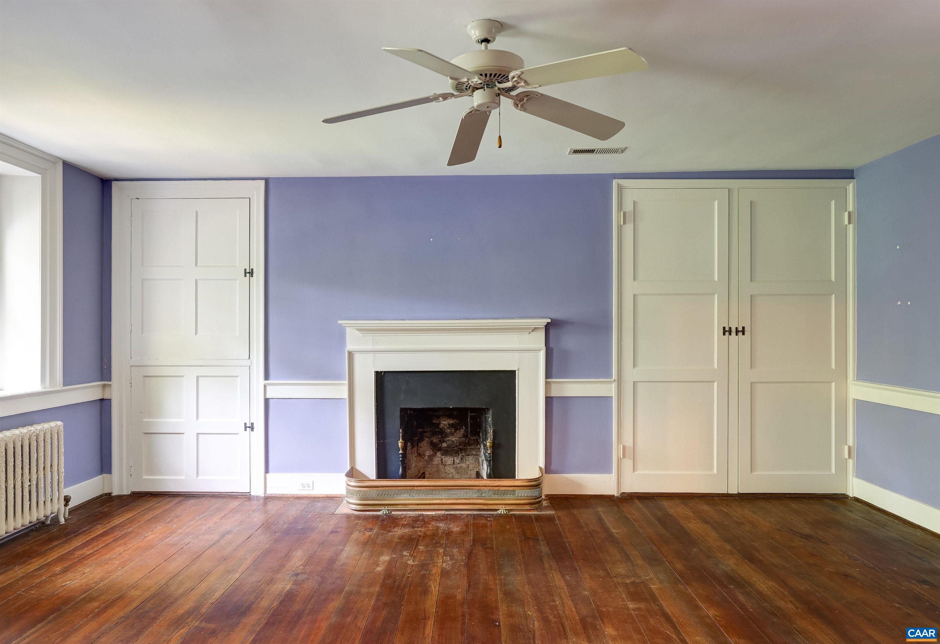 2051 Polo Grounds Road Charlottesville, VA 22911 - Photo 31 of 74 a view of an empty room with wooden floor fireplace and a window