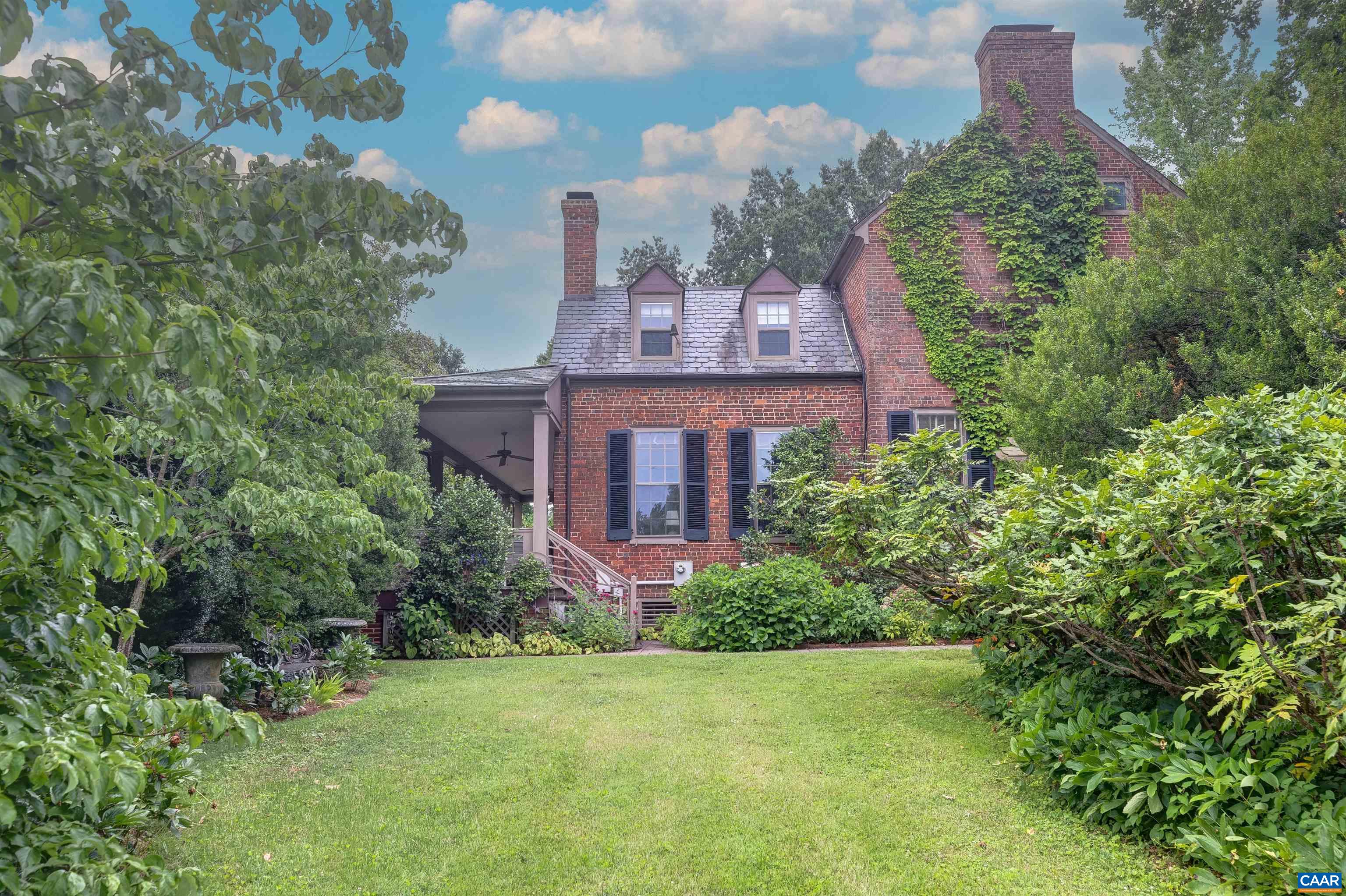 2051 Polo Grounds Road Charlottesville, VA 22911 - Photo 47 of 74 a front view of a house with a yard and fountain