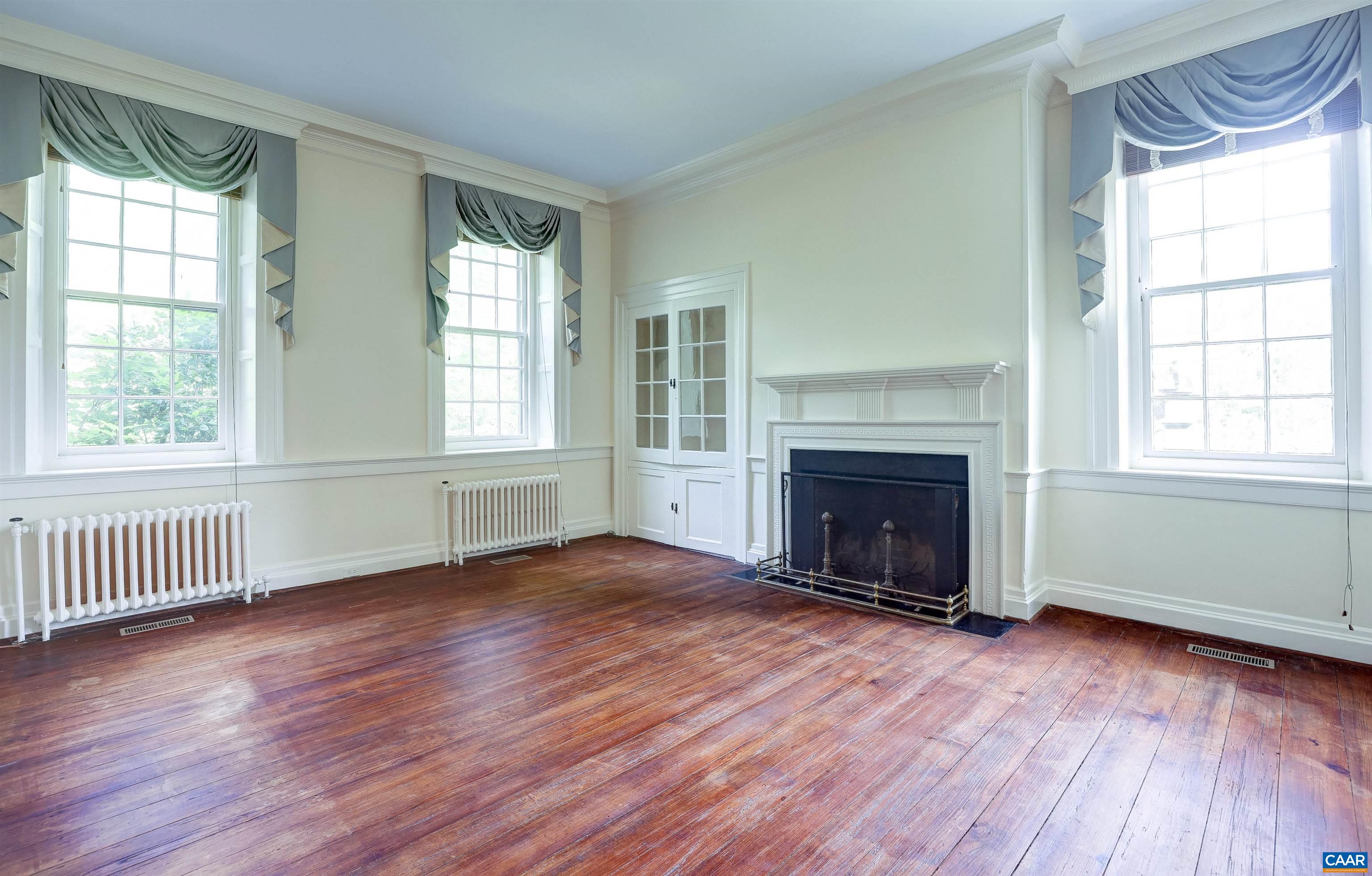 2051 Polo Grounds Road Charlottesville, VA 22911 - Photo 5 of 74 an empty room with wooden floor fireplace and windows