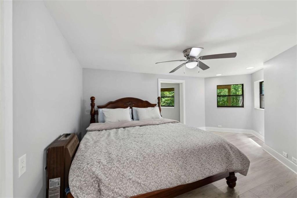 10323 Old CCC Camp Road Chatsworth, GA 30705 - Photo 70 of 97 a bedroom with a bed and a chandelier