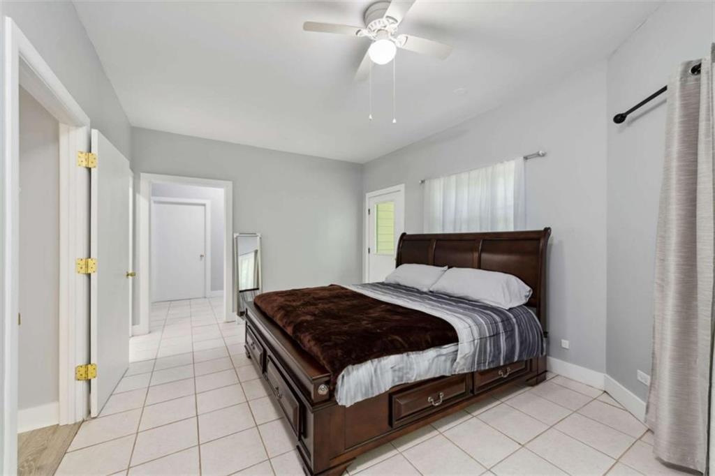 10323 Old CCC Camp Road Chatsworth, GA 30705 - Photo 83 of 97 a bedroom with a bed and a chandelier