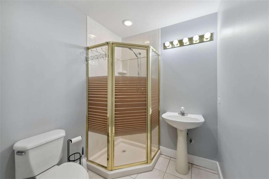 10323 Old CCC Camp Road Chatsworth, GA 30705 - Photo 84 of 97 a bathroom with a shower a toilet a sink and mirror