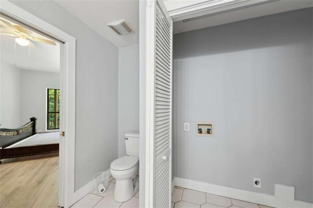 10323 Old CCC Camp Road Chatsworth, GA 30705 - Photo 91 of 97 a bathroom with a granite countertop toilet a sink and a mirror