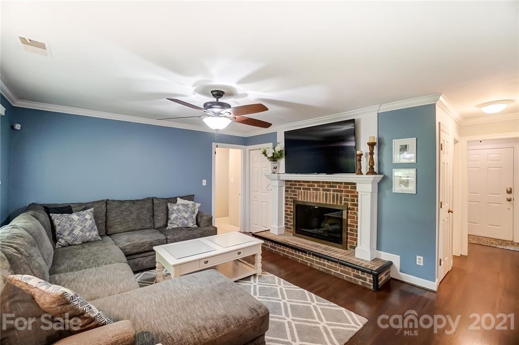 9600 Riddick Place Matthews, NC 28105 - Photo 14 of 38 a living room with furniture flat screen tv and a fireplace