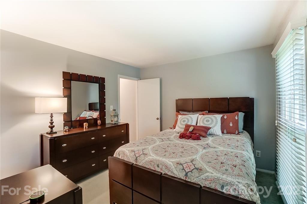 9600 Riddick Place Matthews, NC 28105 - Photo 22 of 38 a bedroom with a bed and a dresser