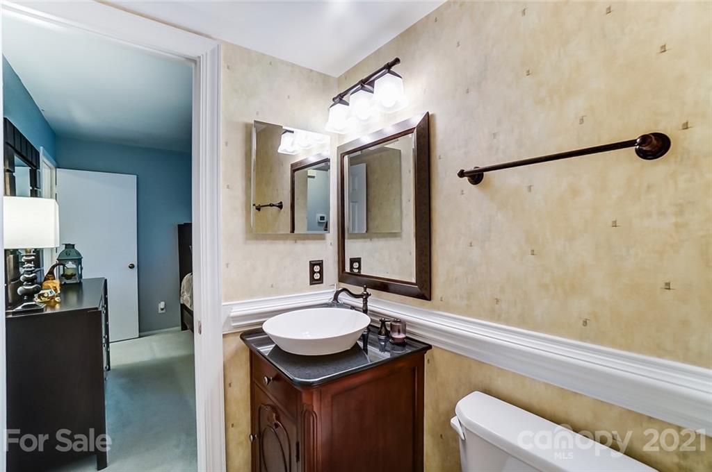 9600 Riddick Place Matthews, NC 28105 - Photo 23 of 38 a bathroom with a sink and mirror