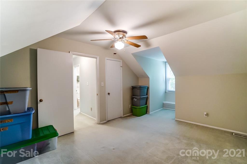 9600 Riddick Place Matthews, NC 28105 - Photo 29 of 38 a view of a room with closet and a ceiling fan