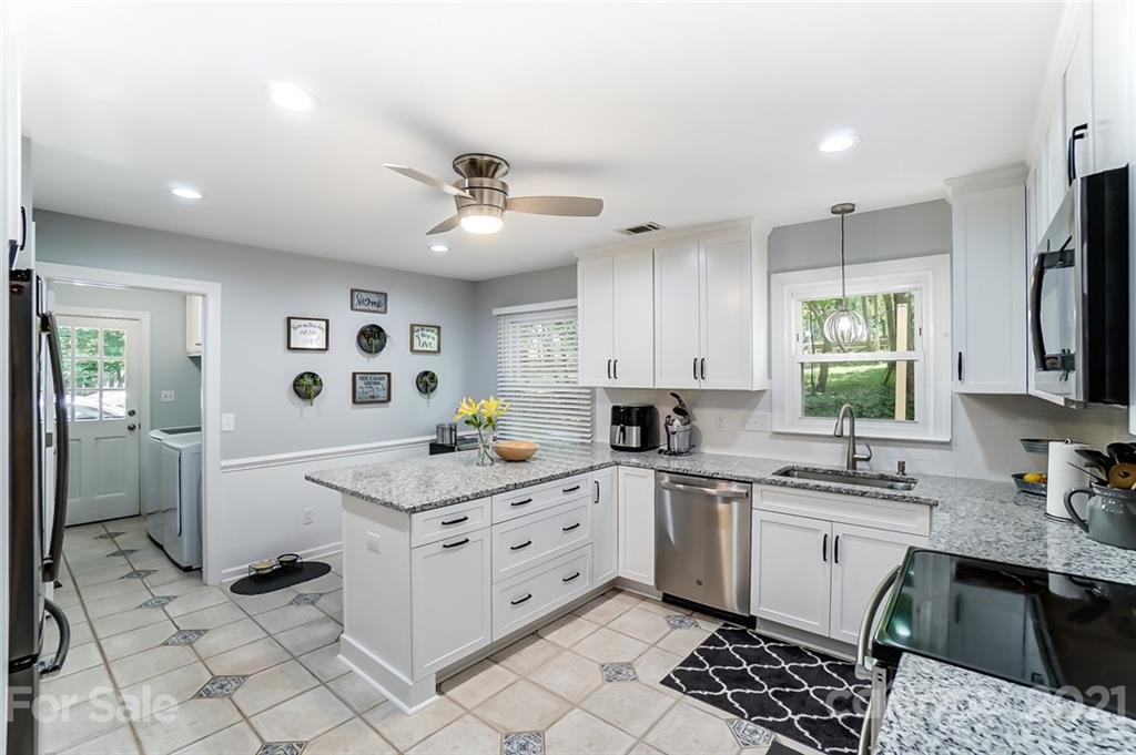 9600 Riddick Place Matthews, NC 28105 - Photo 8 of 38 a kitchen that has a sink a window and stainless steel appliances