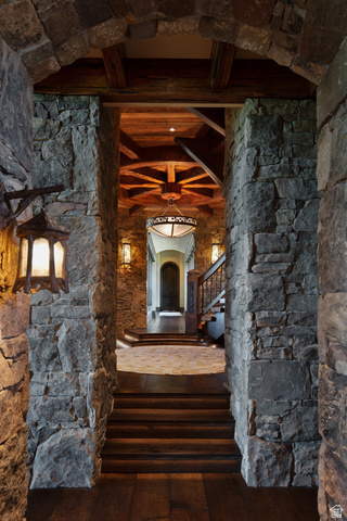 2322 North Westward Ho Road Heber City, UT 84036 - Photo 18 of 54 Corridor with arched walkways, dark wood finished floors, and beamed ceiling
