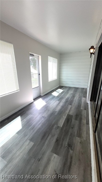 2830 North Lake Damon Road, Unit A Avon Park, FL 33825 - Photo 17 of 20 an empty room with wooden floor and windows