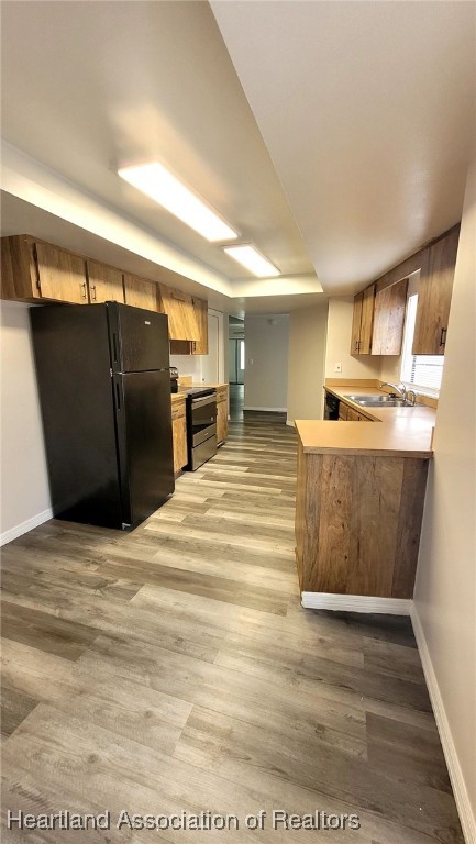 2830 North Lake Damon Road, Unit A Avon Park, FL 33825 - Photo 4 of 20 a kitchen with stainless steel appliances kitchen island wooden cabinets and granite counter tops