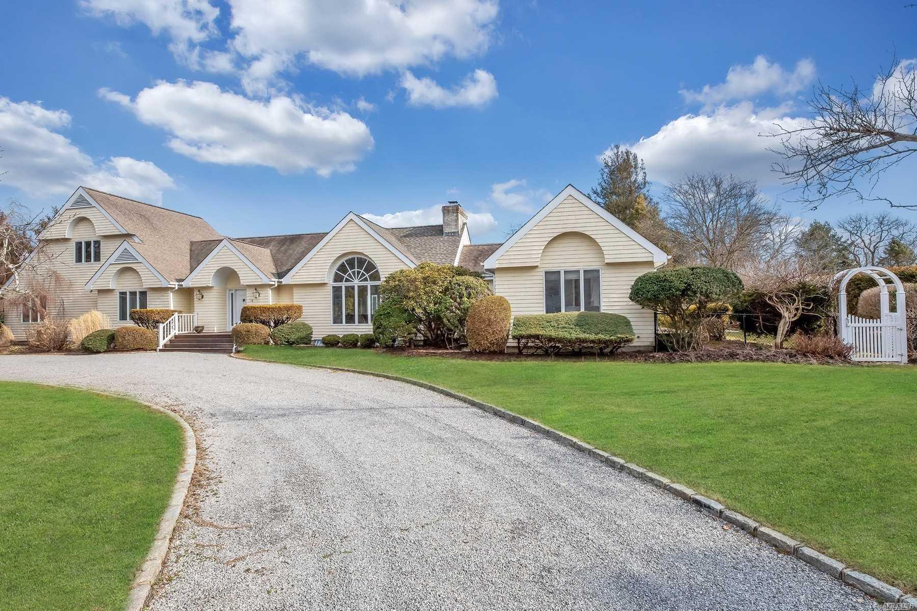 a view of house with garden and tall buildings