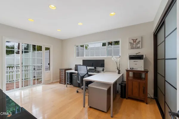 a room with furniture a flat screen tv and a refrigerator