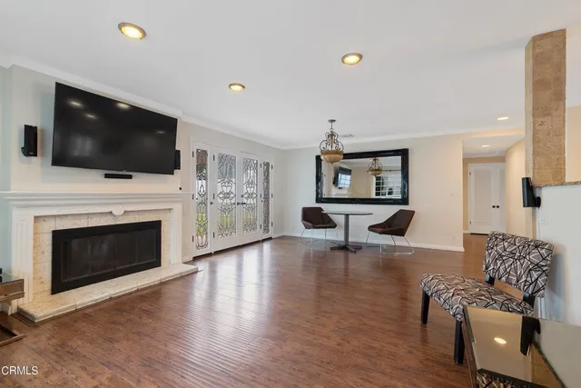 a living room with furniture a flat screen tv and a fireplace