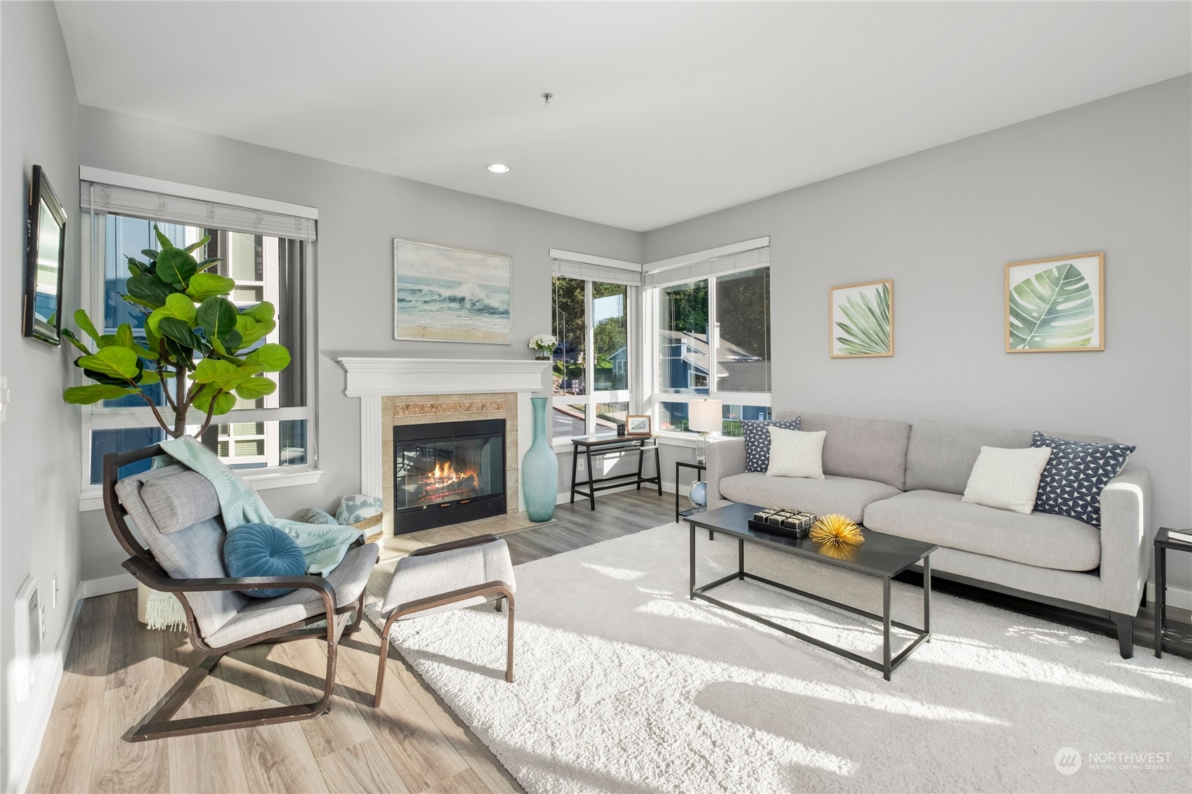 3914 243rd Place Southeast, Unit L203 Bothell, WA 98021 - Photo 1 of 32 a living room with furniture and a fireplace