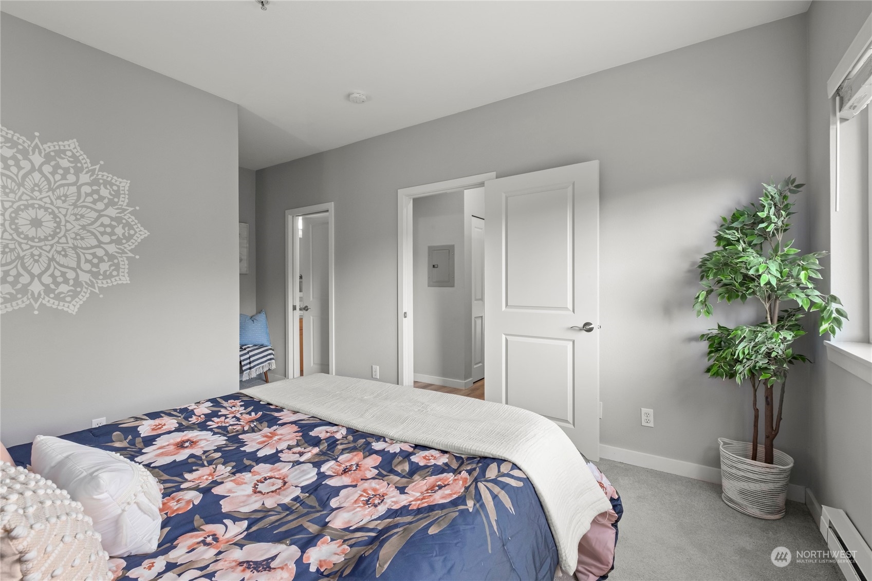 3914 243rd Place Southeast, Unit L203 Bothell, WA 98021 - Photo 17 of 32 a bedroom with a large bed and a potted plant