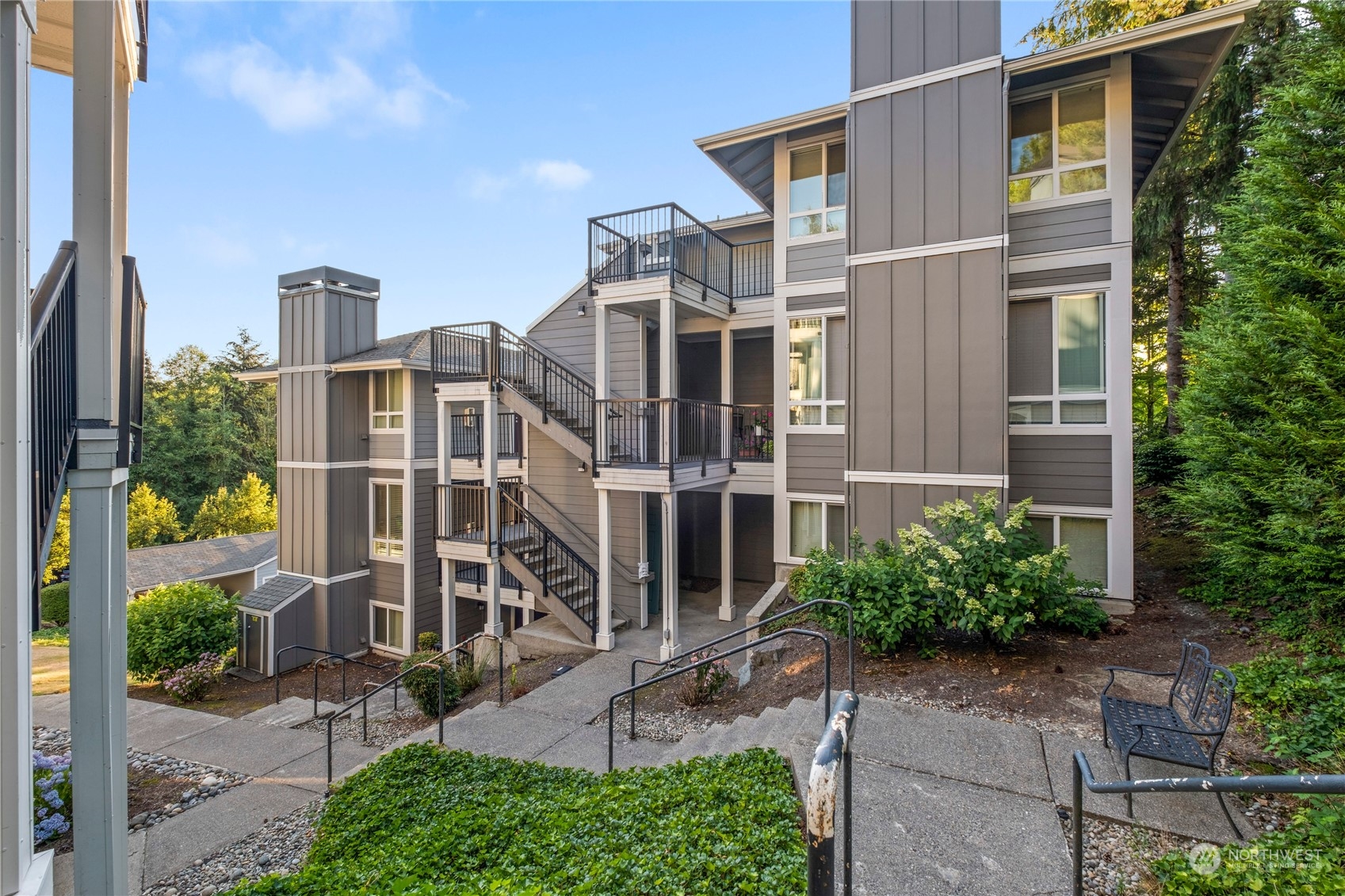 3914 243rd Place Southeast, Unit L203 Bothell, WA 98021 - Photo 2 of 32 a view of a large building next to a yard