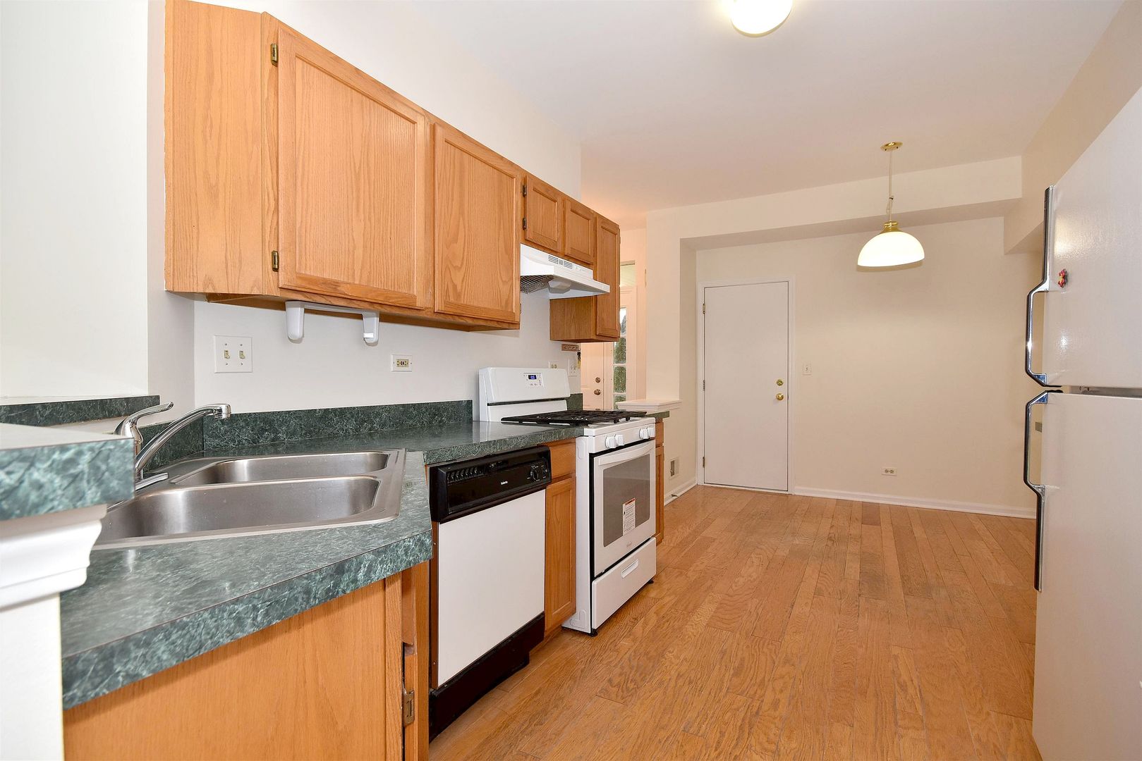 8343 Ripple Ridge Darien, IL 60561 - Photo 12 of 32 a kitchen with granite countertop a sink a stove and cabinets