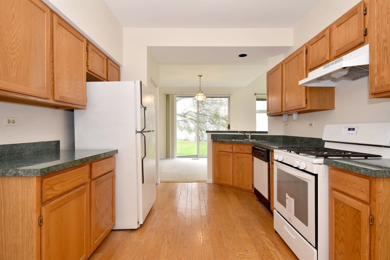 8343 Ripple Ridge Darien, IL 60561 - Photo 13 of 32 a kitchen with stainless steel appliances granite countertop a refrigerator a stove top oven and a sink with cabinets