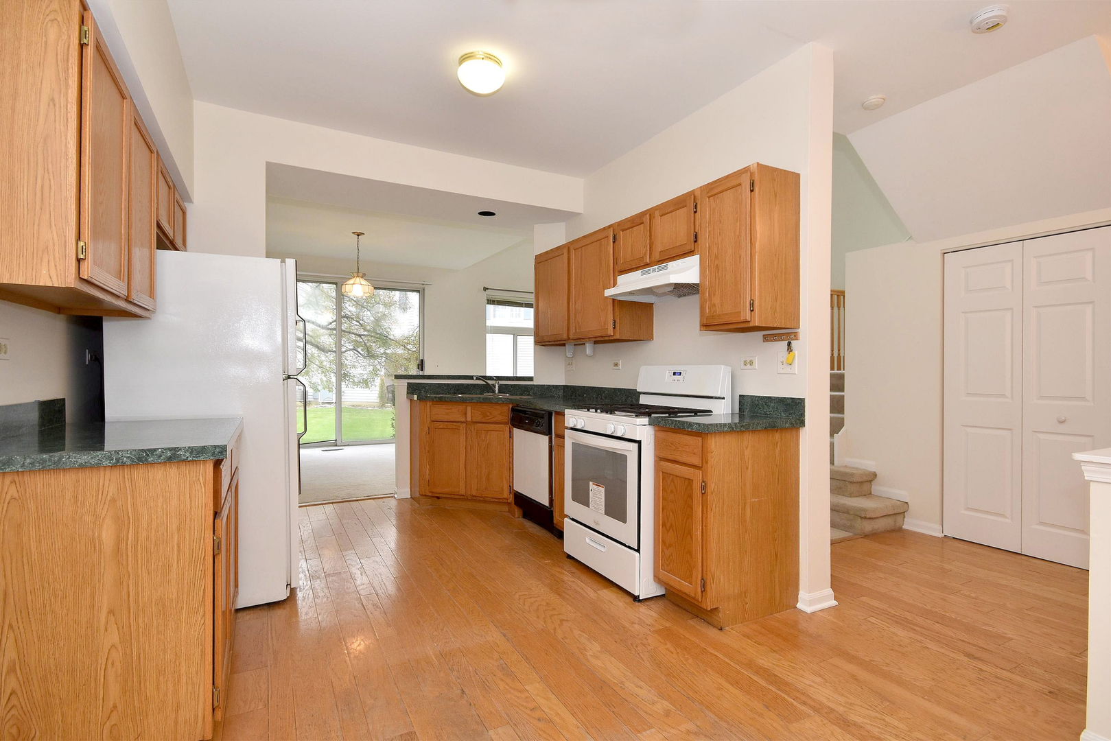8343 Ripple Ridge Darien, IL 60561 - Photo 14 of 32 a kitchen with stainless steel appliances granite countertop a stove a sink and a refrigerator