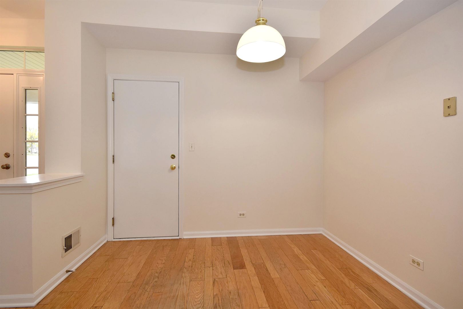 8343 Ripple Ridge Darien, IL 60561 - Photo 19 of 32 a view of a room with wooden floor and white walls