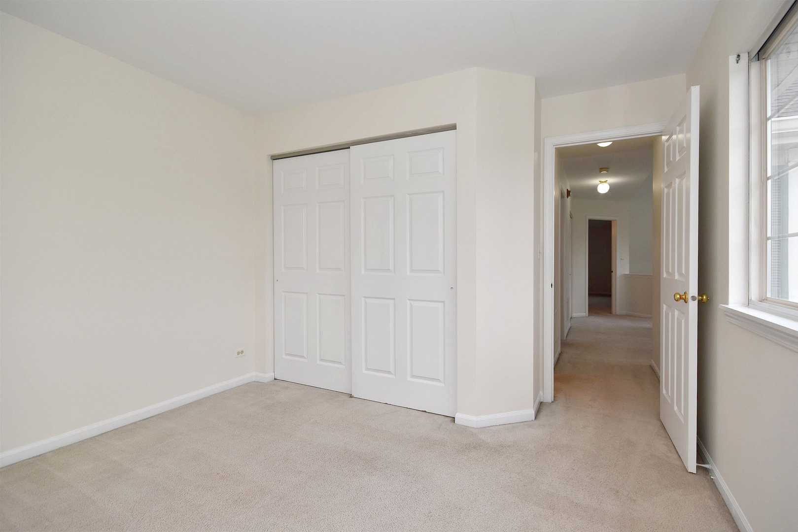 8343 Ripple Ridge Darien, IL 60561 - Photo 30 of 32 an empty room with closet and a hallway