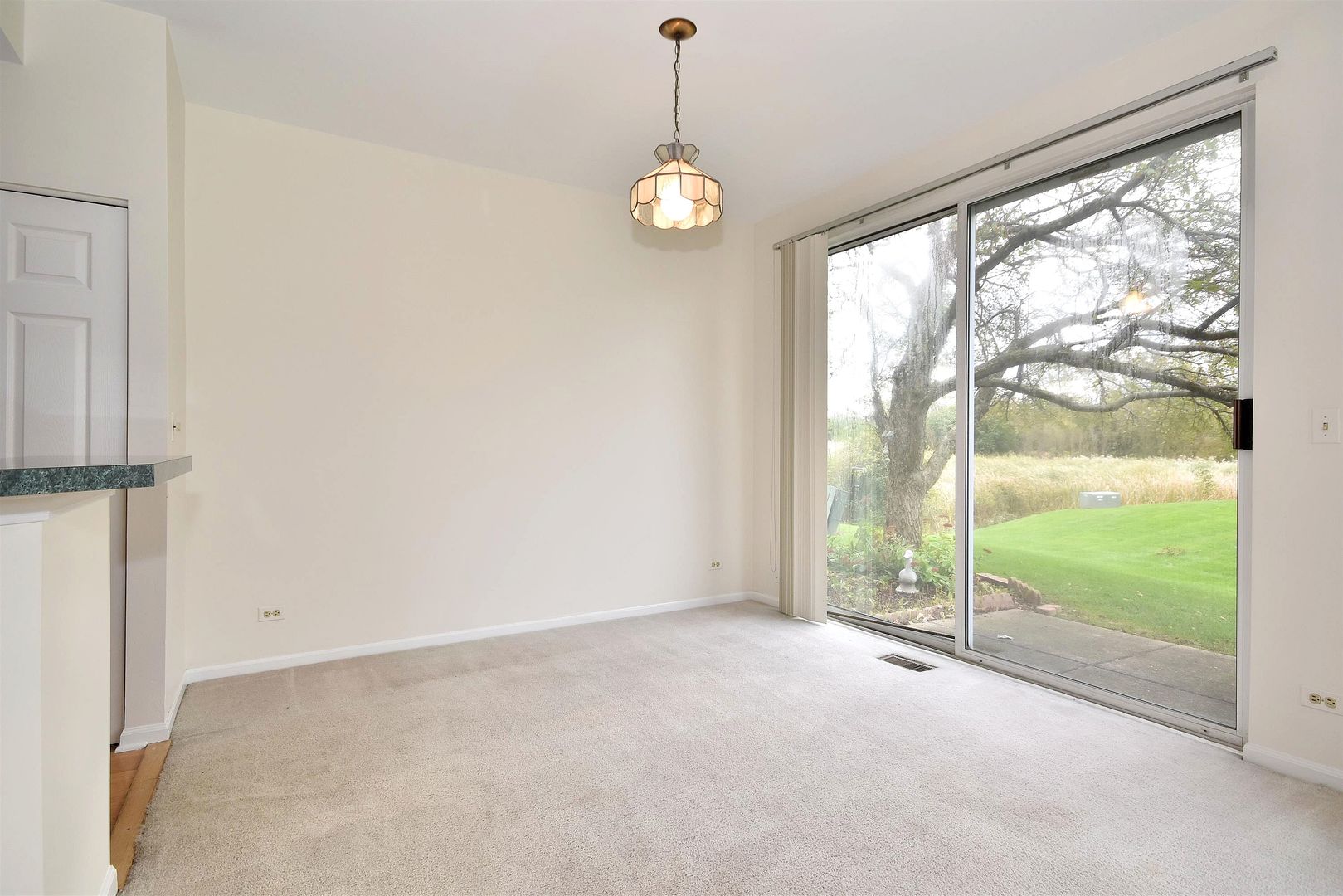 8343 Ripple Ridge Darien, IL 60561 - Photo 7 of 32 a view of an empty room with wooden floor and windows