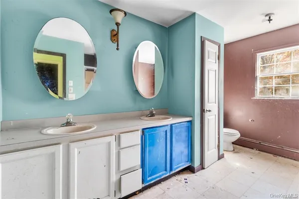 a bathroom with a toilet sink and mirror