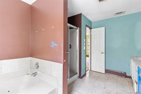 a bathroom with a bathtub and a sink
