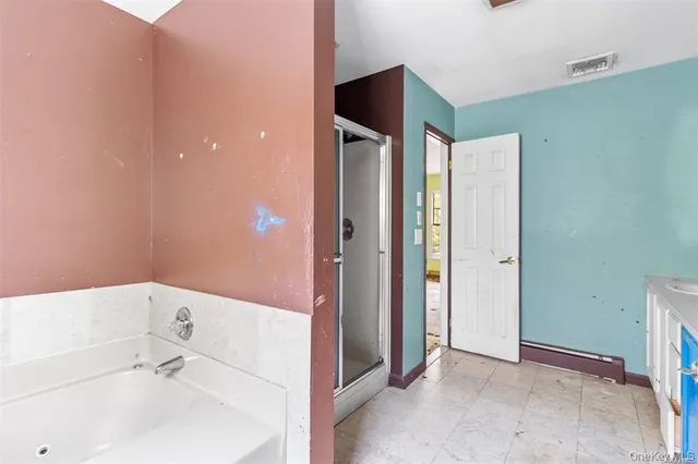 a bathroom with a bathtub and a sink