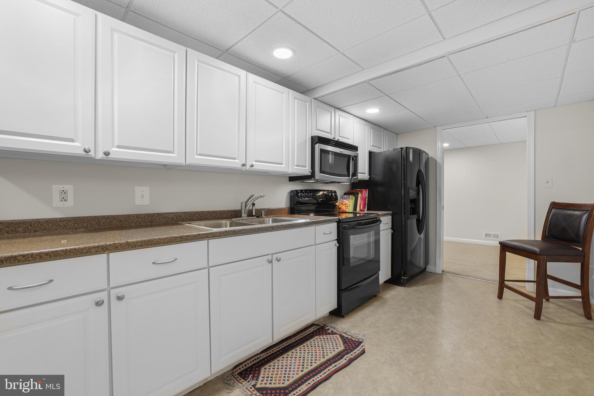 15532 Quince Ridge Lane North Potomac, MD 20878 - Photo 35 of 50 a kitchen with sink cabinets and refrigerator