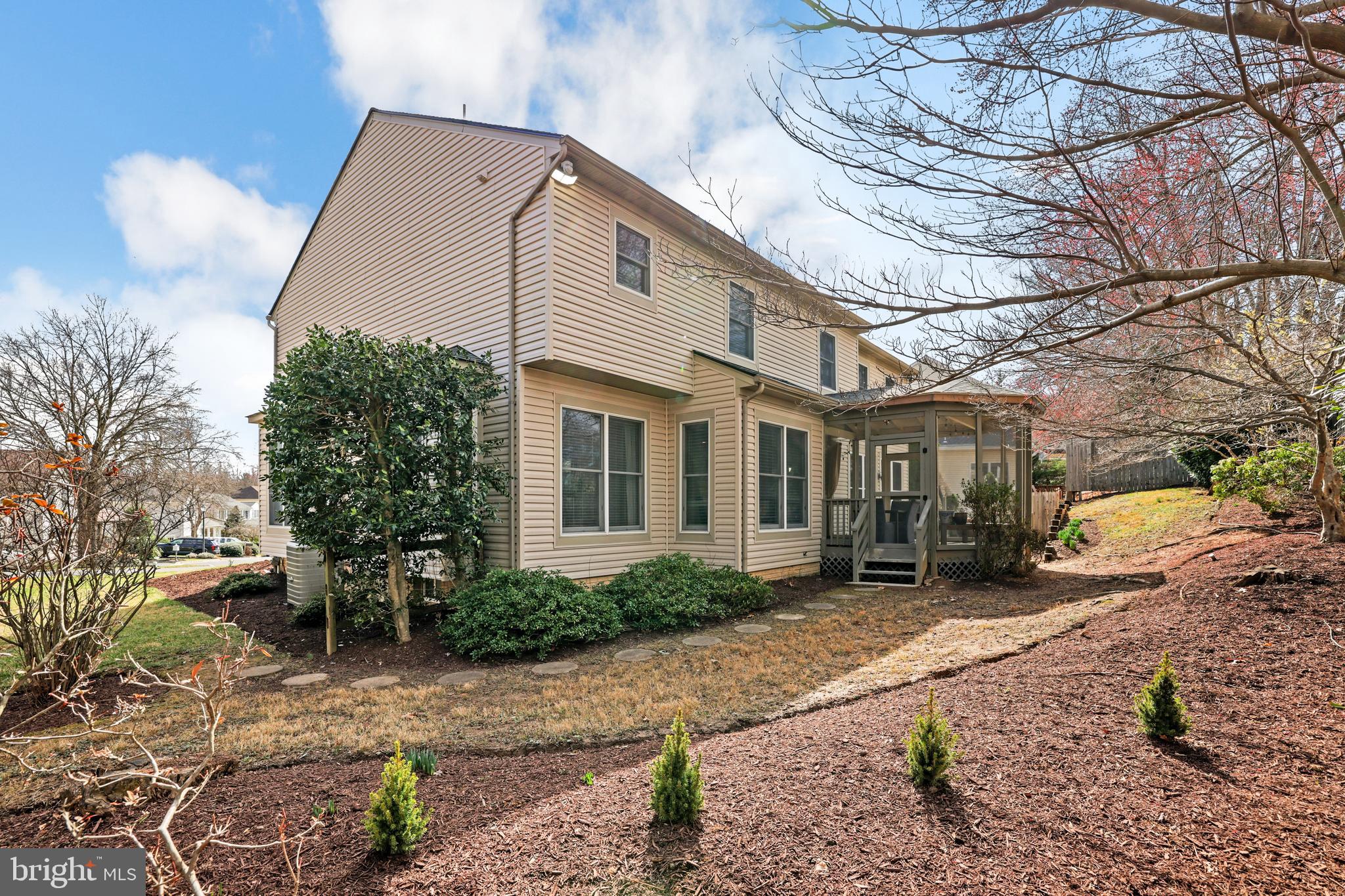 15532 Quince Ridge Lane North Potomac, MD 20878 - Photo 45 of 50 a view of a white house next to a yard with potted plants