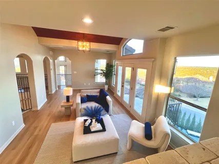 a living room with furniture and a floor to ceiling window