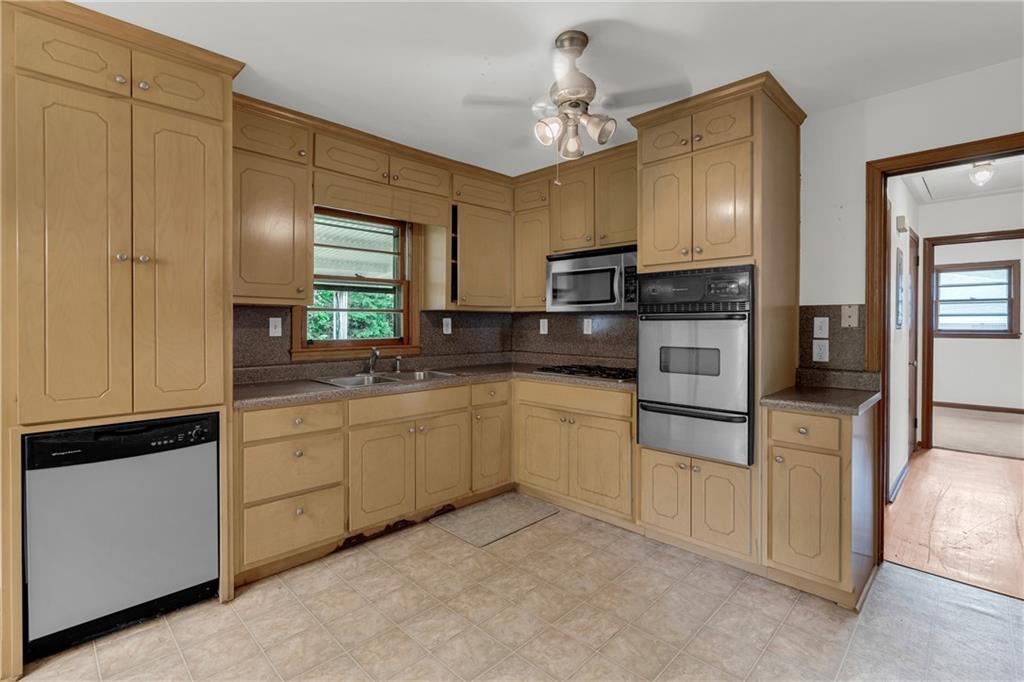 1620 Rock Cut Road Conley, GA 30288 - Photo 14 of 43 a kitchen with white cabinets and white appliances