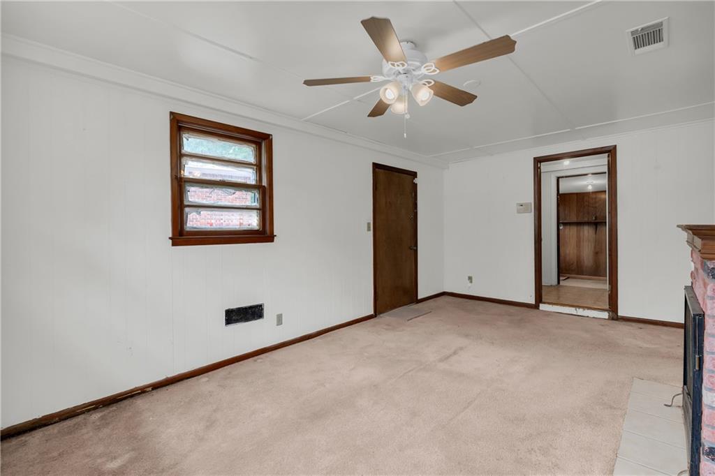 1620 Rock Cut Road Conley, GA 30288 - Photo 16 of 43 an empty room with windows and fan