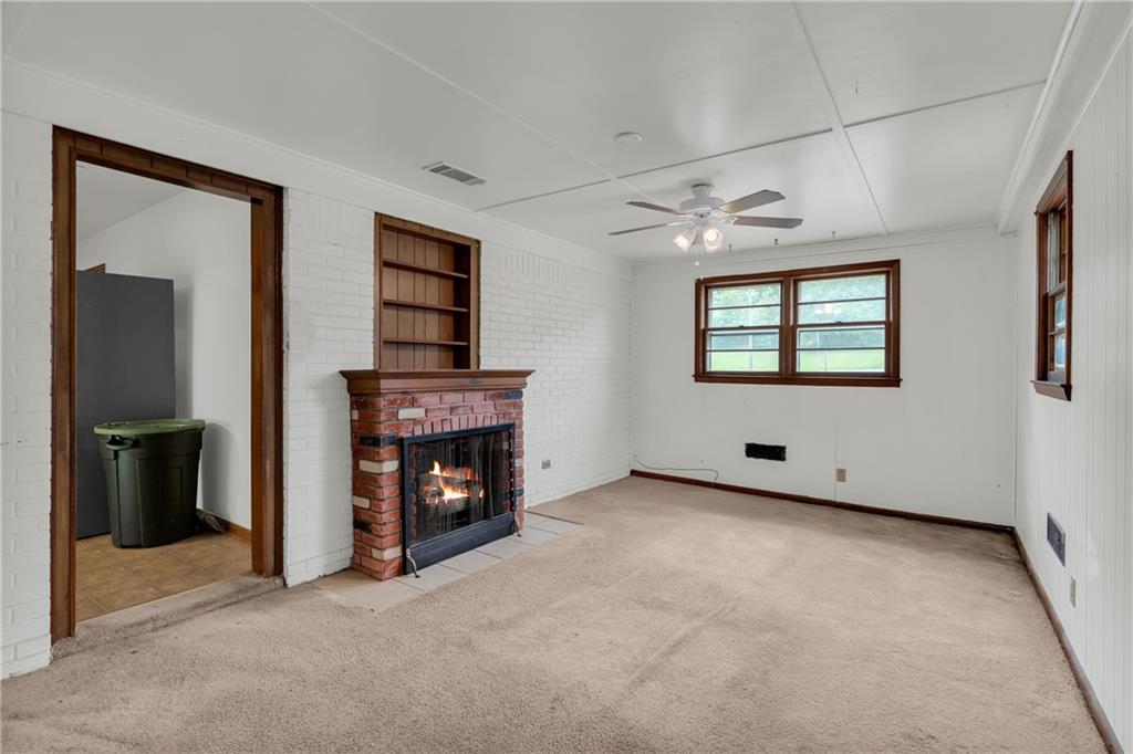 1620 Rock Cut Road Conley, GA 30288 - Photo 17 of 43 an empty room with windows and fireplace