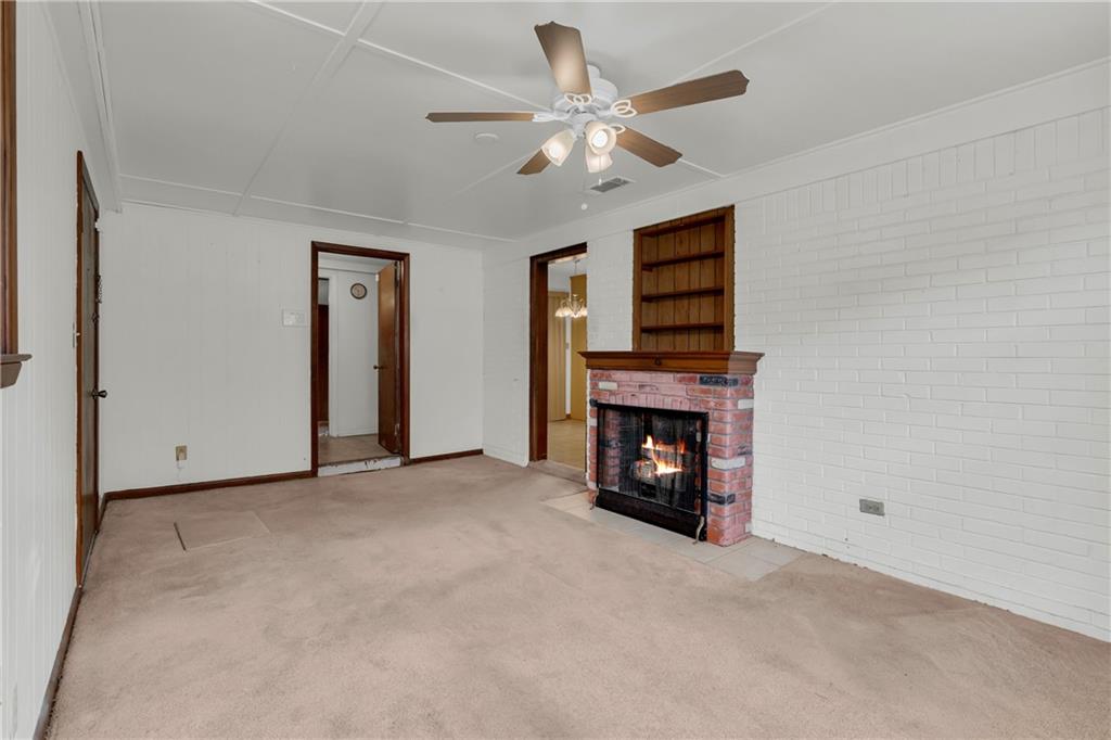 1620 Rock Cut Road Conley, GA 30288 - Photo 18 of 43 an empty room with fireplace and fan