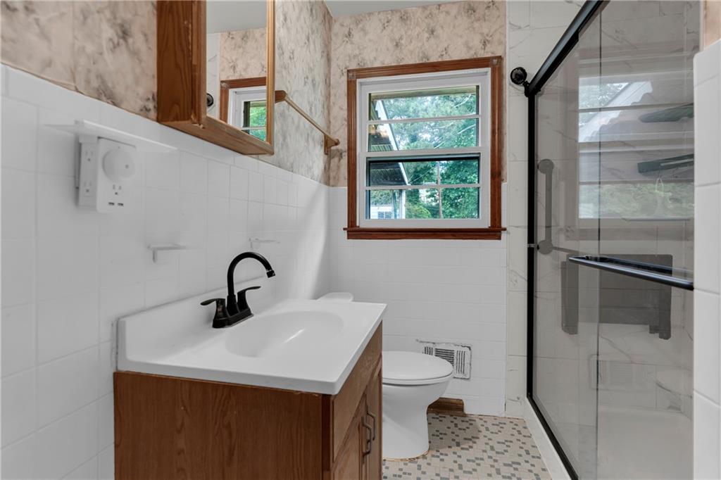 1620 Rock Cut Road Conley, GA 30288 - Photo 20 of 43 a bathroom with a sink toilet and shower